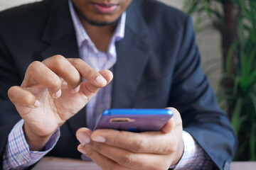  businessman hand using smart phone while sited 
