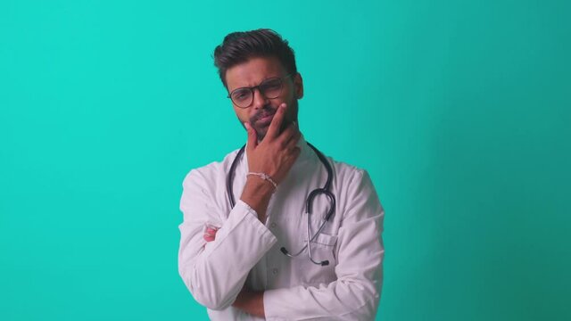 pakistanian doctor in white coat with stethoscope feeling confident mock up over blue studio background