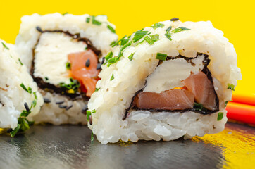 Closeup of smoked salmon, soft cheese and chive California roll