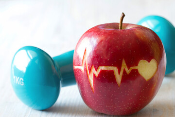 Heartbeat line on red apple and dumbbell, healthy heart diet and sport concept - Powered by Adobe
