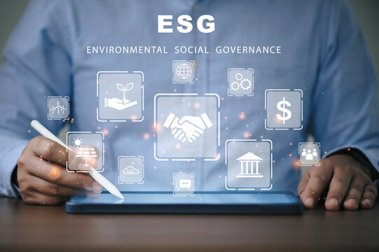 Businessman using the tablet for analysis ESG environmental social governance business strategy investing concept.