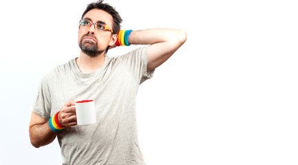 Obraz premium Dark haired man wearing glasses and a bracelet with rainbow colors; with tired expression