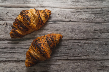 Chocolate croissant on a gray wooden table