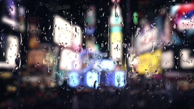 Rainfall in Time Square New York view from the window. Rain drops falling with bokeh lights of city at night. Raining in the city traffic. 4k