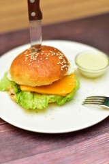hamburger on a plate with a knife