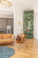 luxury interior of a spacious apartment in an old 19th century historical house with modern furniture. high ceiling and walls are decorated with stucco
