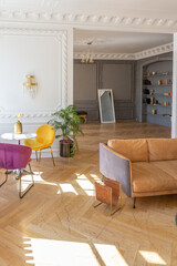 luxury interior of a spacious apartment in an old 19th century historical house with modern furniture. high ceiling and walls are decorated with stucco