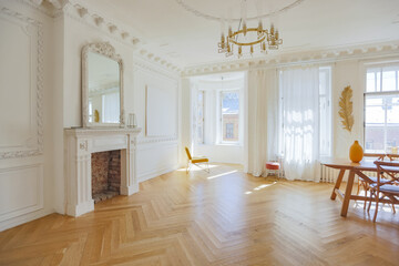 luxury interior of a spacious apartment in an old 19th century historical house with modern furniture. high ceiling and walls are decorated with stucco