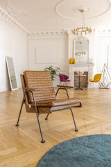 luxury interior of a spacious apartment in an old 19th century historical house with modern furniture. high ceiling and walls are decorated with stucco