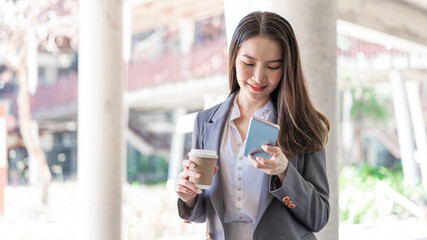 Working woman concept a young female manager attending video conference and holding a cup of coffee