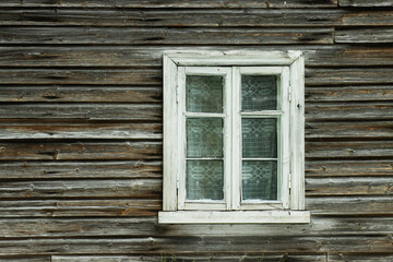 An old and rustic wooden window with glass in Estonian countryside, Northern Europe. 