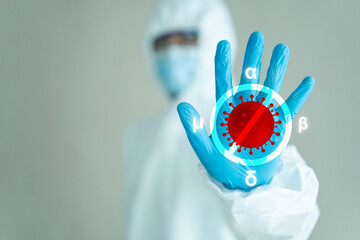 Medical service staff in personal protection equipment suit - PPE showing a hand sign means stop...