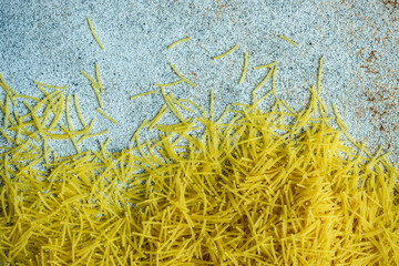 Mini macaroni pasta on concrete background