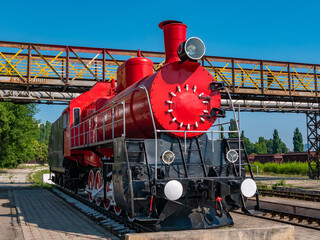 Old steam locomotive at the railway station. Close-up.