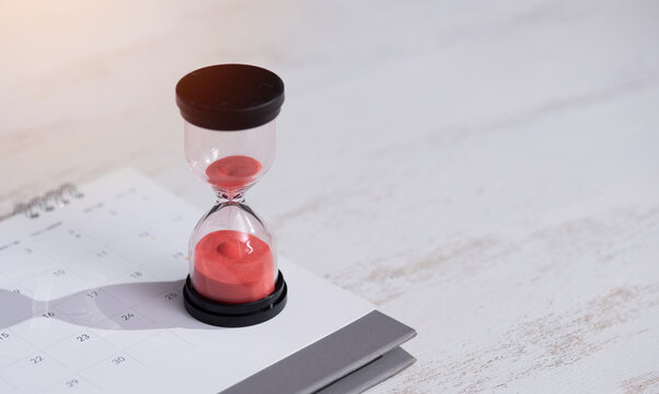 Hourglass And Calendar On Table,Time Passing Concept.