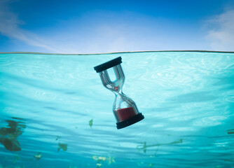 Fototapeta na wymiar Time concept Hourglass diving in ocean