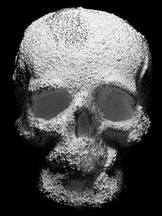 3d render monochrome black and white of abstract art with surreal scary creepy Halloween skull head with small balls particles on surface in white plastic and silver glossy metal material on black 