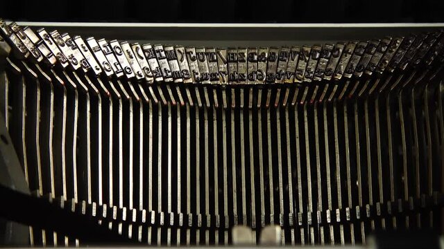Mechanism of a retro typewriter. Old typewriter hammers. Slow motion. Close up.