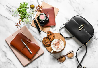 Women's office desk - notebooks, organizer, tablet, cappuccino cup and cookies with chocolate drops...