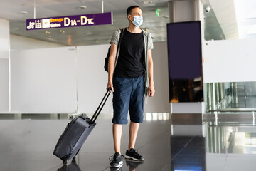 Fototapeta na wymiar Man wearing disposable medical mask in airport during coronavirus pneumonia outbreak. Protection and prevent measures while epidemic time.