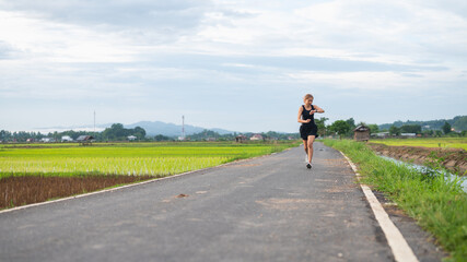 Woman using smart watch during training outdoors.