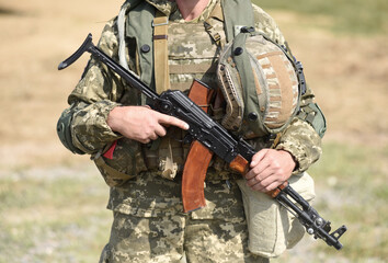 Soldier of Ukraine Ukrainian soldier with assault rifle AK.