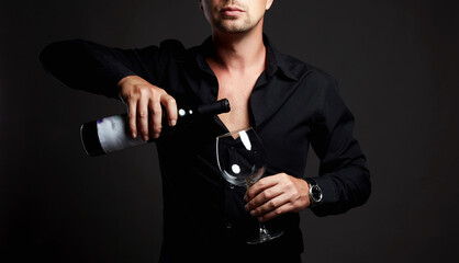 Fototapeta na wymiar Man with Wine. Man with bottle of wine and wineglass