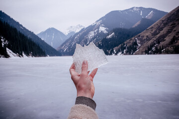 hand holding a snow in mountains