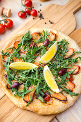 focaicca pizza with rucola salomon lime olives