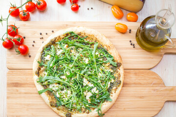Focaccia with  rucola  and cheese on wooden board