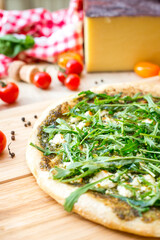 Focaccia with  rucola  and cheese on wooden board