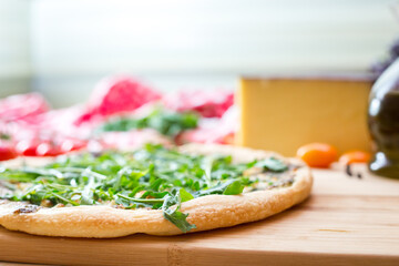 Focaccia with  rucola  and cheese on wooden board