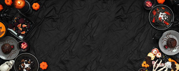 Halloween dinner party double border over a dark black banner background. Top view. Spooky...