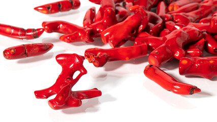 Shiny different natural  red corals close up on a white background.  Isolated jewelry with...
