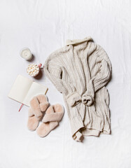 a sweater, coffee and a candle on a white background . winter cozy image
