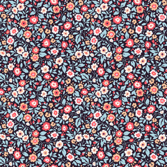 Vintage floral background. Floral pattern with small coral, white and red flowers on a dark violet background. Seamless pattern for design and fashion prints. Ditsy style. Stock vector illustration.