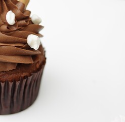 Dark chocolate cupcake white candy background with copy space