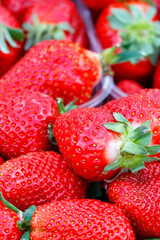 Ripe big red strawberry close-up on the table. Vertical image.