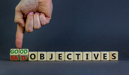 Good or bad objectives symbol. Businessman turns wooden cubes, changes words bad objectives to good objectives. Beautiful grey background, copy space. Business, good or bad objectives concept.