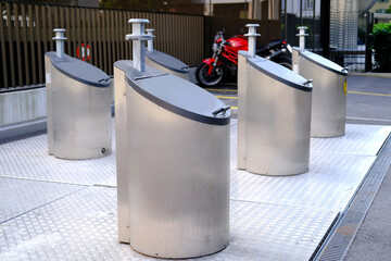 row of metal waste containers for separate sorting at public urban waste collection site in...