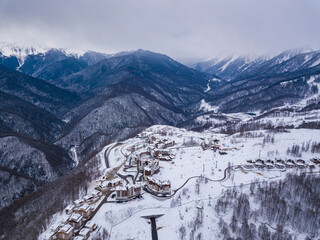 Winter aerial view of the Olympic mountain village Roza Plato. Beautiful winter landscape from drone.