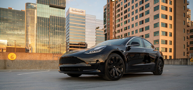 Black Tesla Model 3 Parked on an Atlanta Rooftop at Sunset