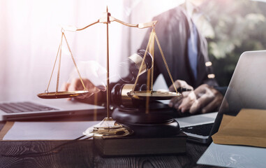 Business and lawyers discussing contract papers with brass scale on desk in office. Law, legal...