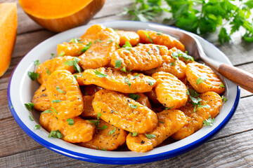 Gnocchi with a pumpkin on the plate. Italian dumplings with butter.