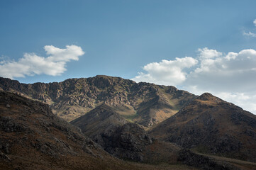 Fototapeta na wymiar Rocky Mountains with foliage and cloudy sky, Rocky Mountain khuzestan province, Iran