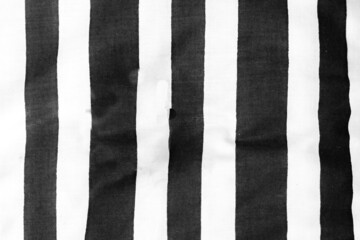 Black and white striped cloth laid out roughly to provide vertical blank lines.