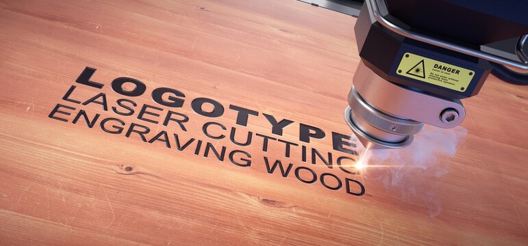 Laser cutter close up, engraved logo on a wooden board. 