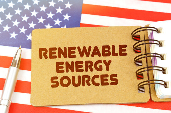 On the US flag lies a notebook with the inscription - renewable energy sources