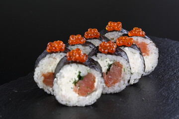 roll with salmon on a black background