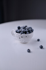 blueberries in a white cup - copy space
